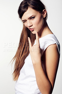 Buy stock photo A funky young beauty giving you devil horns and pouting with attitude
