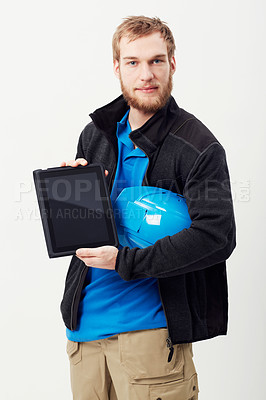 Buy stock photo Portrait of an unshaven young man showing you a digital tablet