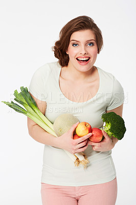 Buy stock photo Happy young woman holding a variety of fruit and veg