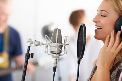 Buy stock photo Music studio, woman singer with microphone and headphones for performance with talent. Recording, art and girl musician singing on live streaming, song for record label and professional audio sound.