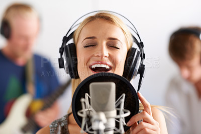 Buy stock photo Happy woman, singer and microphone with headphones in music recording studio, sound track or podcast. Female person, blonde or musician smile on mic for audio listening, content creation and karaoke