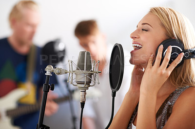 Buy stock photo Music, performance and woman with microphone, headphones and singing band with talent. Recording studio, art and happy girl musician live streaming song for record label, sound and audio broadcast.