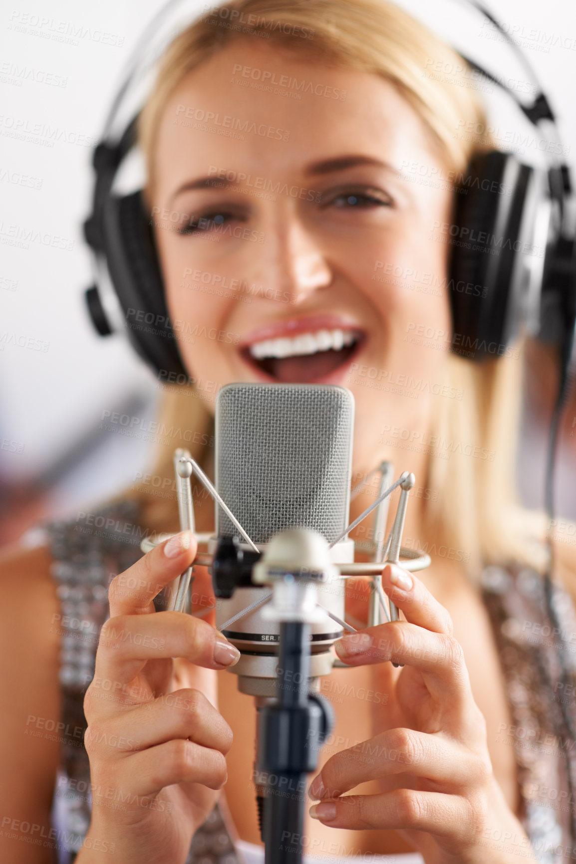 Buy stock photo Music studio, singer and woman with microphone, headphones and performance with portrait of talent. Voice, art and face of happy girl musician singing song for record label, sound and audio broadcast