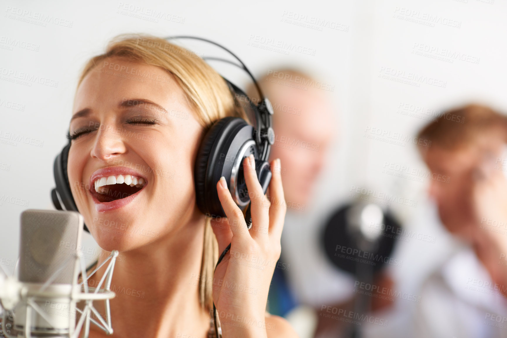Buy stock photo Music, singing and woman with microphone, headphones and band performance with talent. Recording studio, smile and happy girl musician live streaming voice for record label, sound and audio broadcast