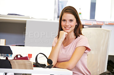 Buy stock photo Cropped portrait of a young businesswoman sitting at her desk