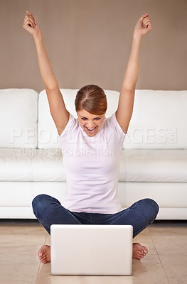 Buy stock photo Full length shot of an attractive young woman feeling cheerful and celebrating while using her laptop at home