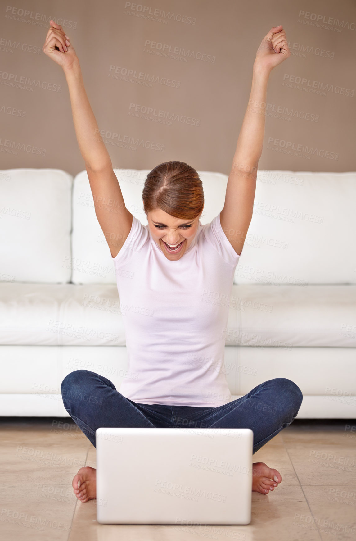 Buy stock photo Full length shot of an attractive young woman feeling cheerful and celebrating while using her laptop at home