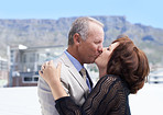 Kissing against a scenic backdrop