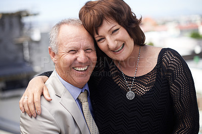 Buy stock photo An affectionate mature couple embracing against a scenic view of the city