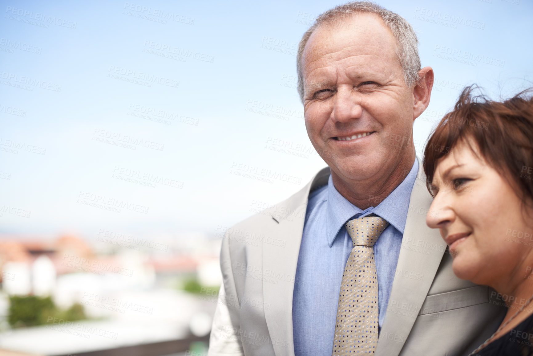 Buy stock photo An affectionate mature couple embracing against a scenic view of the city - copyspace