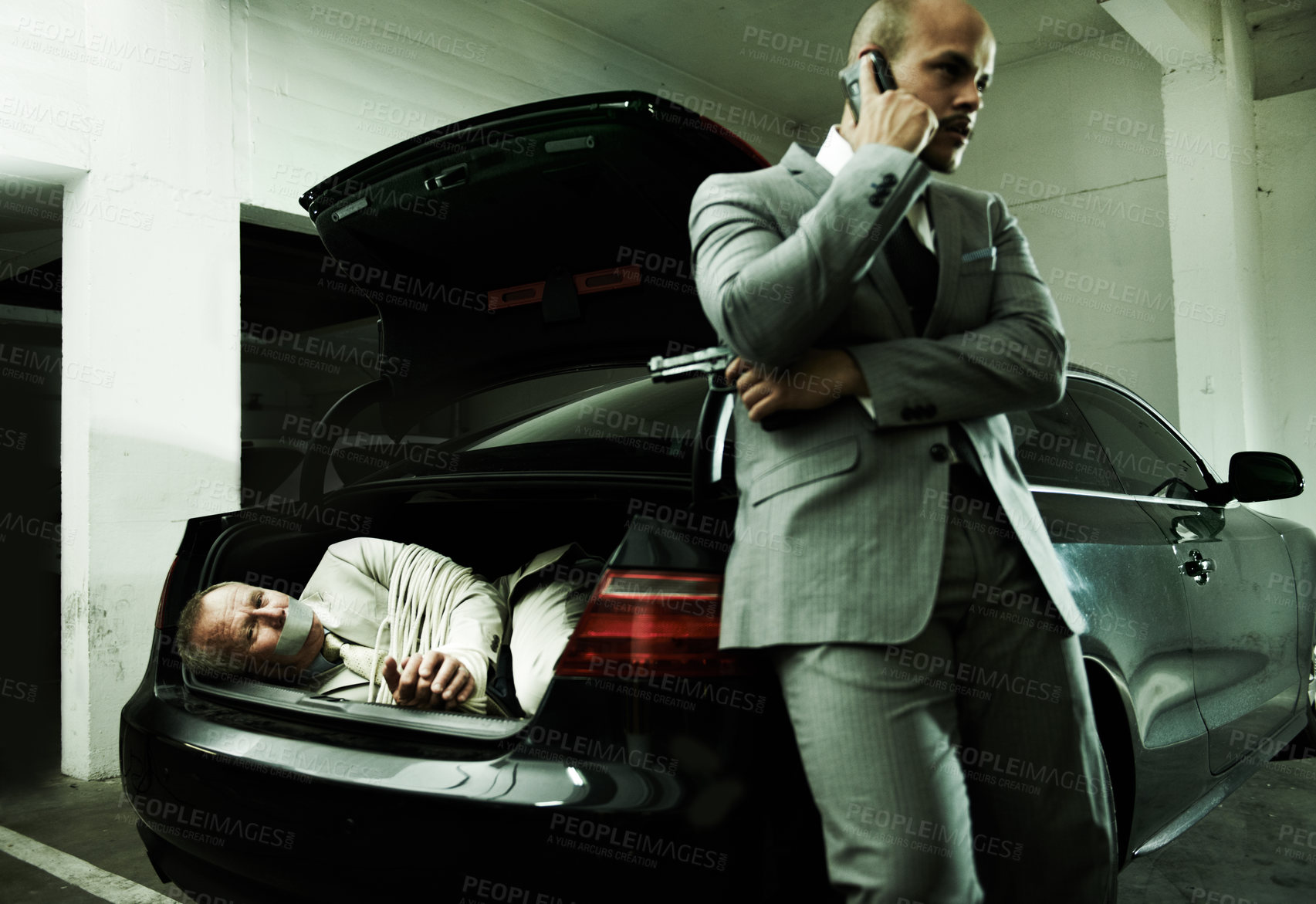 Buy stock photo Phone call, car and man with hostage in trunk for negotiation, kidnapping danger and crime. Mafia, gangster criminal and business person in boot for financial crisis, debt and payment in parking lot