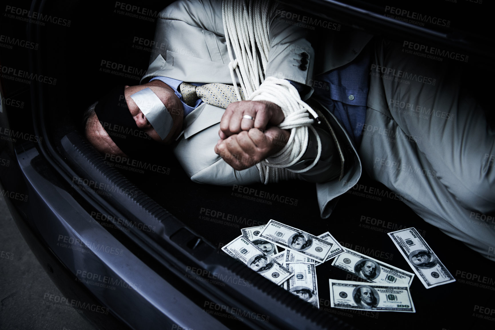 Buy stock photo Man, tied up and kidnap in car with money, ransom and crime for wealth, debt or financial negotiation. Person with blindfold, rope and cash in trunk for abduction, danger and risk or scared for life