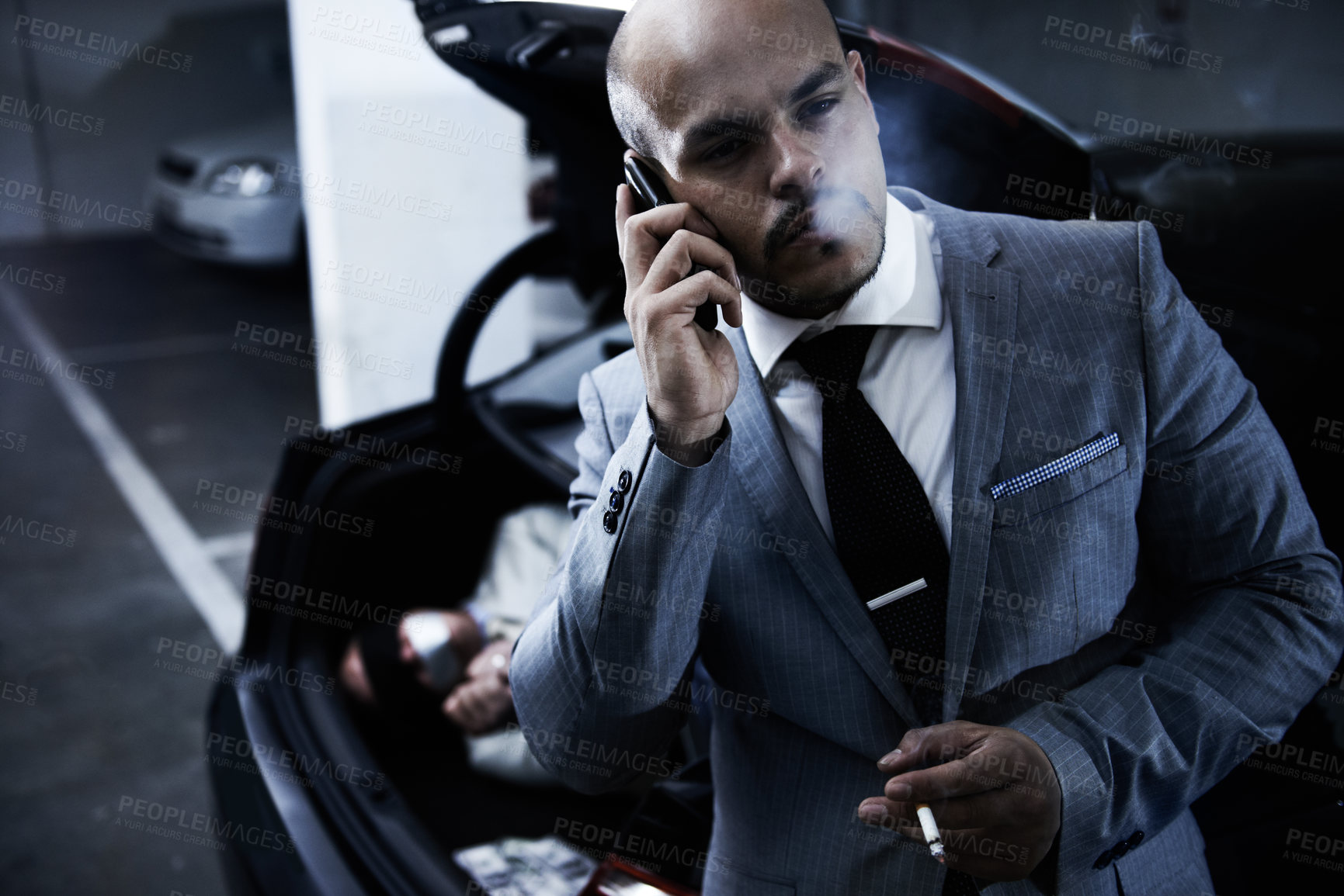 Buy stock photo Phone call, mafia and man with hostage in trunk for negotiation, kidnapping danger and ransom. Crime, gangster criminal and business person in boot for abduction, terrorism and robbery in parking lot