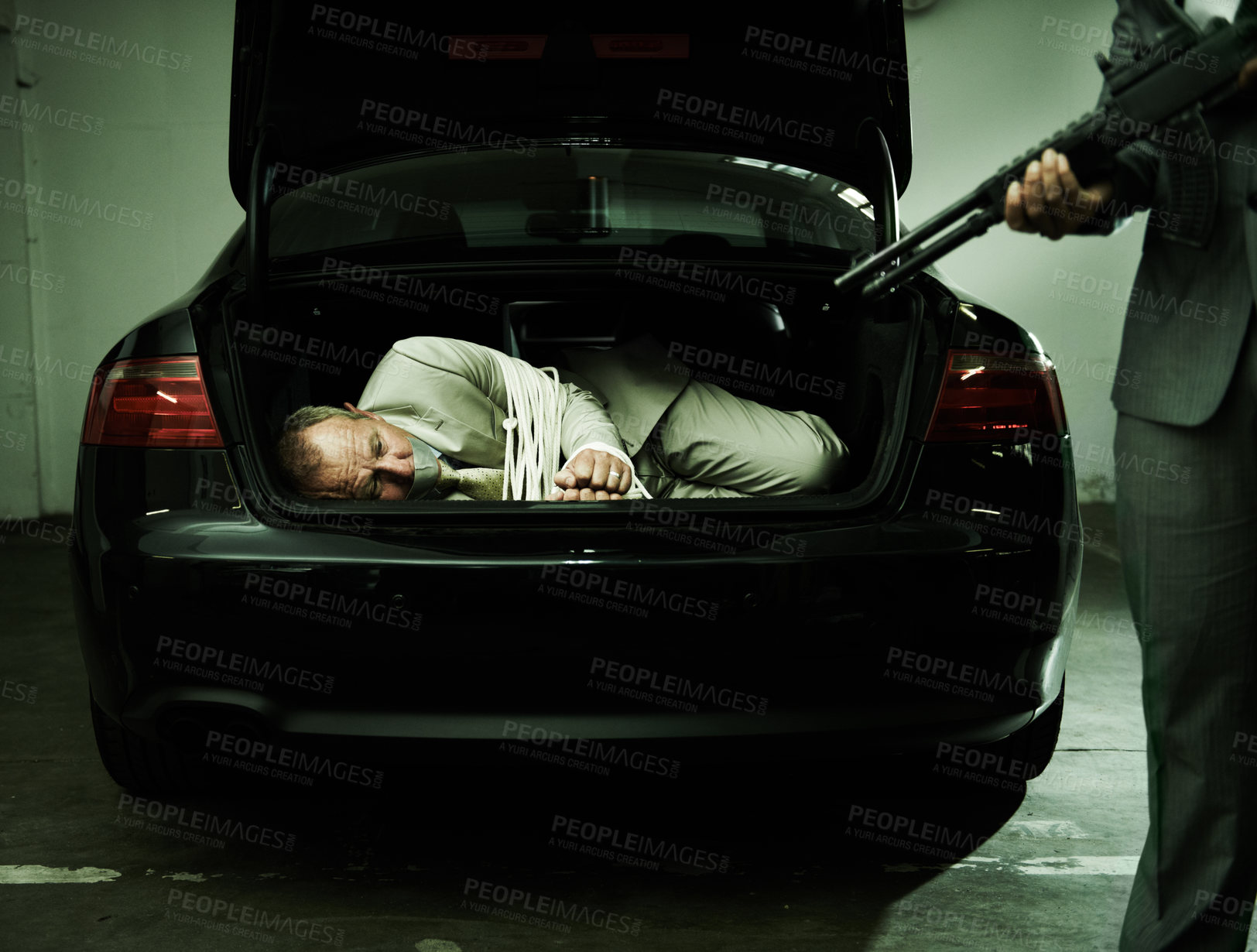 Buy stock photo Man in trunk of car, kidnapping and gun with mafia, danger and violence in basement garage. Crime, human trafficking and scared person tied with rope parking lot with gangster, robbery and terror.