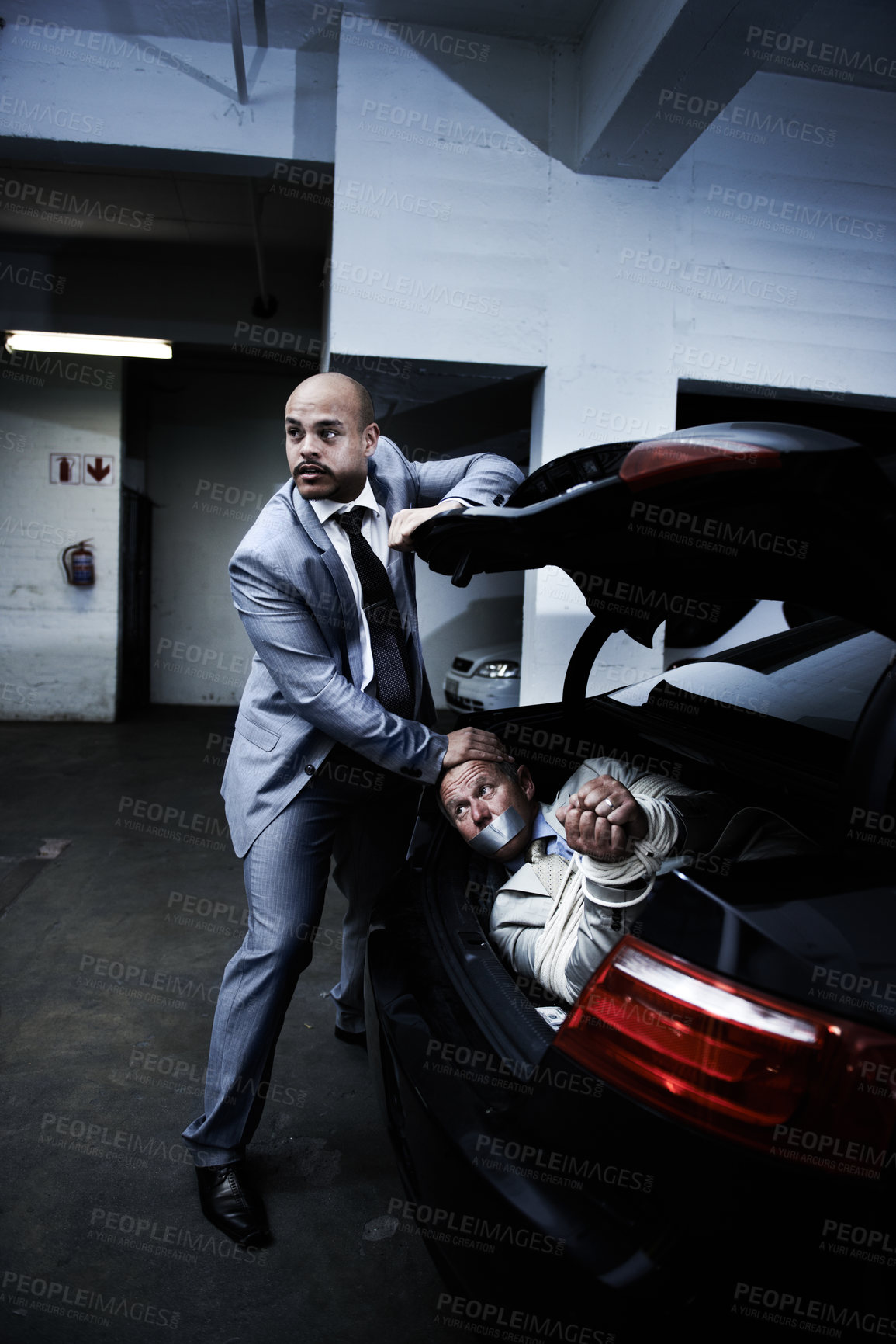 Buy stock photo Man in trunk kidnapping and mafia with fear, danger and violence in basement garage. Crime, human trafficking and scared person tied with rope in car in parking lot with gangster, ransom and terror.