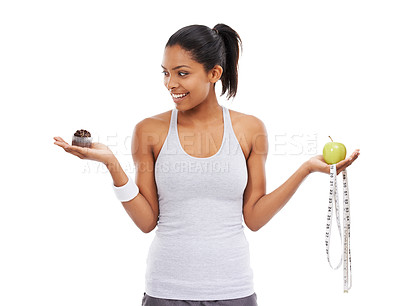 Buy stock photo Woman, apple and cake choice for diet in studio for weight loss decision, healthy eating or white background. Female person, hands and fruit or cupcake as mockup or tape measure, training or wellness