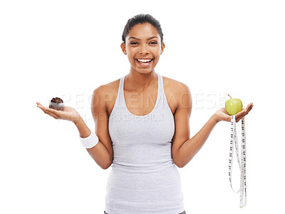Buy stock photo Portrait, woman and decision of an apple or cupcake in studio isolated on white background for fitness. Exercise, smile and choice with a happy young athlete holding a measuring tape to lose weight 