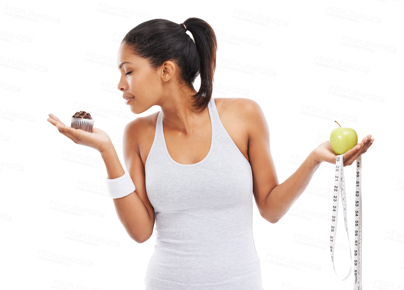 Buy stock photo Woman, cupcake and choice or fruit decision in studio healthy, nutrition benefits or weight loss. Female person, dessert and apple in hands for balance or mockup space, wellness or white background