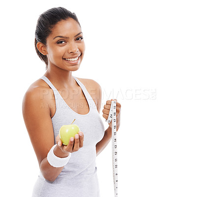 Buy stock photo A pretty young woman offering you an apple and a measuring tape while isolated on white
