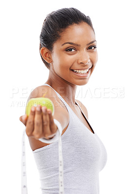 Buy stock photo Happy woman, portrait and lose weight with a measuring tape and apple in white background or studio. Indian, model and healthy food for results in fitness, wellness and diet with nutrition and fruit