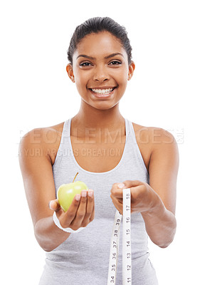 Buy stock photo Woman, portrait and lose weight with a measuring tape and apple in white background or studio. Happy, model and healthy food for results in fitness, wellness and diet with nutrition and fruit