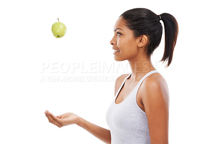 Buy stock photo Health, diet and a woman throwing an apple in studio isolated on a white background for nutrition. Profile, fitness or exercise with a happy young athlete catching a natural green fruit for wellness