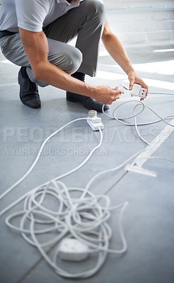 Buy stock photo Hands, man and electrician plug connection, power and electricity in office. Cord, wire and cable on floor, socket and energy of worker, professional or employee charging on technology in workplace