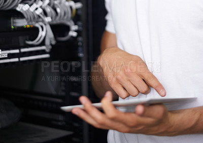 Buy stock photo A computer technician browsing the internet on his digital tablet