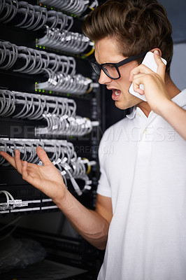 Buy stock photo Server room, man and phone call for cable, connection or glitch in network, cybersecurity or confused in night at job. Technician, angry person or smartphone for talk, questions or report system fail