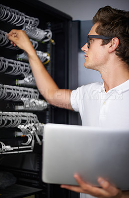 Buy stock photo Server room, information technology and man with laptop, check connectivity and night job. Cybersecurity system, it network or person for internet, data center and storage with cables for database