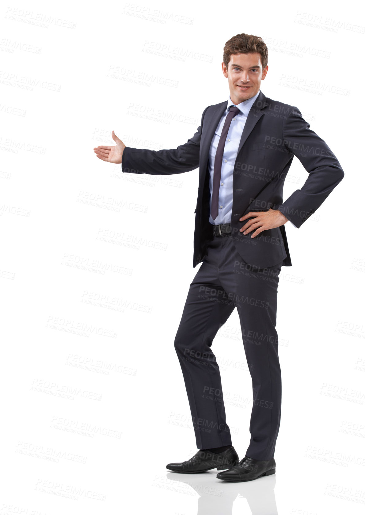 Buy stock photo Studio shot of a well dressed businessman showing you copyspace against a white background