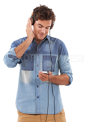 Buy stock photo Technology, music and headphones with casual man in studio isolated on white background for streaming. Relax, smile or audio player with young guy listening to radio on sound device for entertainment