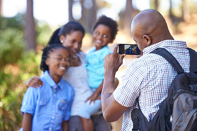 Buy stock photo Happy black family, photography and nature for hiking, bonding or outdoor photo together. African mother, children and father or photographer smile taking picture on phone for adventure in forest