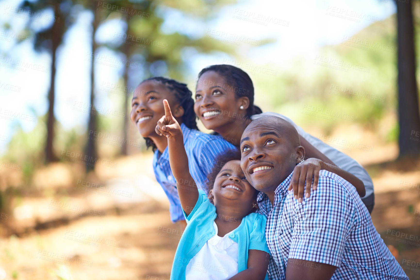 Buy stock photo Happy family, children and pointing in forest for bonding, adventure or outdoor holiday in nature. African mother, father and kids smile for fun day in support, love or weekend exploring in the woods