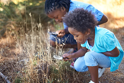 Buy stock photo Children, magnifying glass and explore nature outdoor for education, vacation journey or wildlife discover. Siblings, grass park and forest for research on mountain field or adventure, holiday or fun
