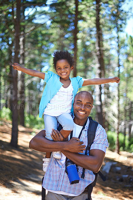Buy stock photo A happy young african father playing with his daughter while outdoors in nature