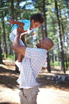 Buy stock photo Playing, father and child in forest with smile, happiness and adventure in nature for summer holiday fun. Bonding, black man and playful son in woods for vacation, trekking in trees and energy games.