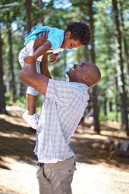 Buy stock photo Playing, dad and kid in forest with smile, happiness and adventure in nature for summer holiday in trees. Bonding, black man and playful son in woods for vacation, trekking in woods and energy games.