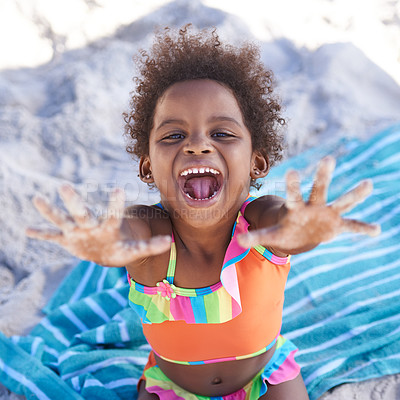 Buy stock photo Excited, child and portrait on beach sand on towel, relax and summer holiday in sunshine in nature. Black, young girl or face by hand gesture on vacation, cape town or playing by ocean in outdoor