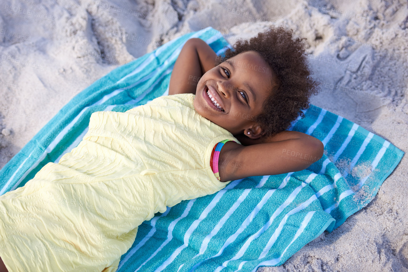 Buy stock photo Happy, african child and portrait on beach sand, relax and summer holiday with sunshine in nature. Black girl, young and smile face on towel on vacation, cape town and seaside for wellness in outdoor