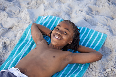 Buy stock photo Portrait, beach sand and towel with child to relax and summer holiday with sunshine in nature. Black teenager, face and smile for leisure on vacation, cape town and seaside for wellness in outdoor