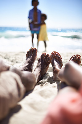 Buy stock photo Feet of family on beach, relax and holiday with children, waves and sunshine on tropical island travel together. Black man, woman and kids on ocean vacation in summer with adventure, peace and sky.