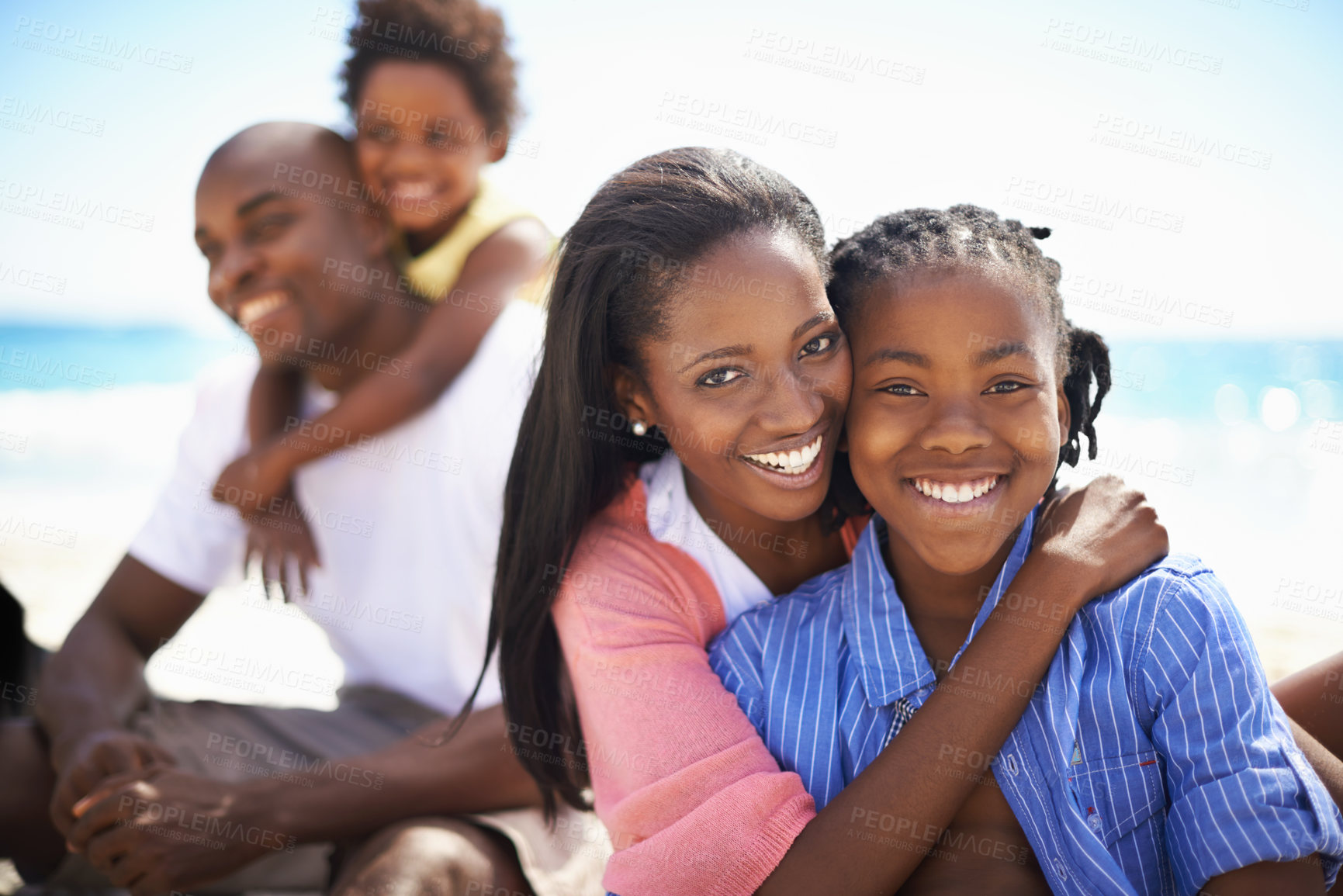 Buy stock photo African family, parents or children and hugging at beach for adventure, holiday or vacation in summer. Black people, face or smile outdoor in nature for embrace, experience or bond and relationship
