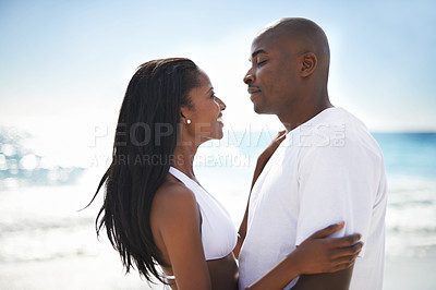 Buy stock photo Happy, love and young black couple at the beach for valentines day vacation, holiday or adventure. Smile, romance and African man and woman on a date by the ocean or sea on weekend trip together.