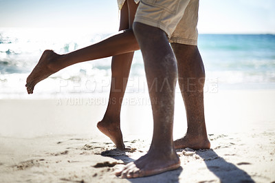 Buy stock photo Legs, hug and a couple on the beach for love on their anniversary or valentines day in summer together. Nature, sea or ocean with a man and woman embracing on the sand at the coast for romance