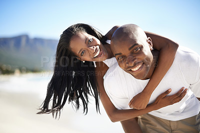 Buy stock photo Piggyback, love and portrait of black couple at the beach for valentines day vacation, holiday or adventure. Happy, smile and African man and woman on a date by the ocean on weekend trip together.