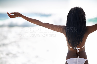 Buy stock photo Black woman on beach in bikini, relax and stretching on holiday in waves, sunshine and travel from back. Sea, happiness and girl on ocean vacation in summer with adventure, peace and blue sky horizon
