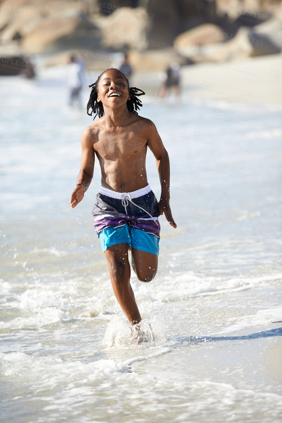 Buy stock photo Running, black boy and happiness on beach with energy for adventure, holiday or vacation in summer. African kid, face and smile outdoor in nature for break, experience or getaway by ocean or sea 