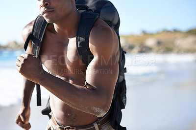 Buy stock photo Backpack, fitness and black man running on beach for workout, exercise or outdoor cardio by ocean coast. Closeup of African male person or runner jogging with bag for adventure by the sea in nature