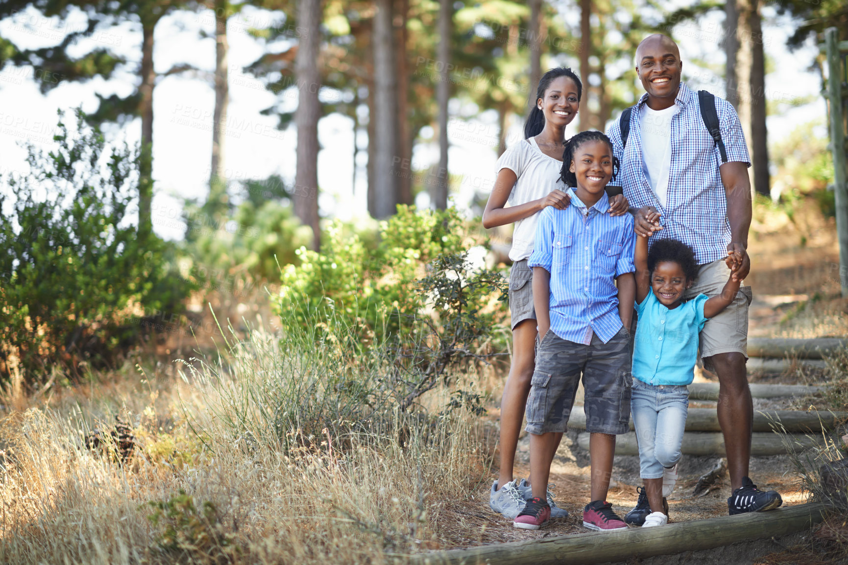 Buy stock photo Portrait of an african american family enjoying a day out in the forest
